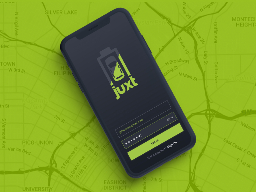 Device mockup of the Juxt Mobile screen sitting on top of a green monochromatic street view map